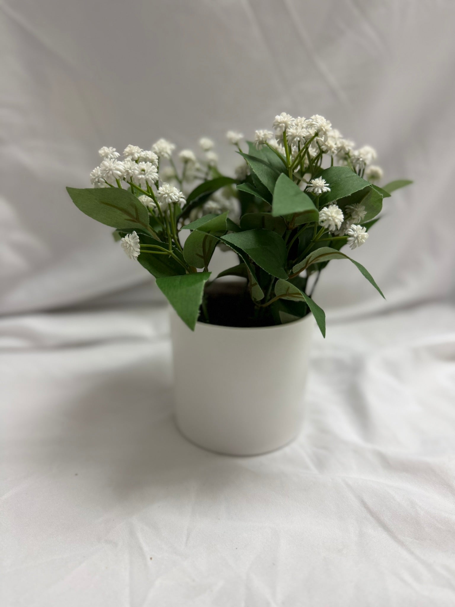 FAUX BUDS AND STEMS IN WHITE POT